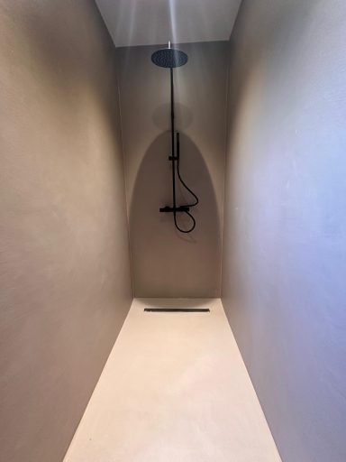 Mikrozement Boden Wand Dusche in einem minimalistischen, modernen Badezimmer mit offener Gestaltung.